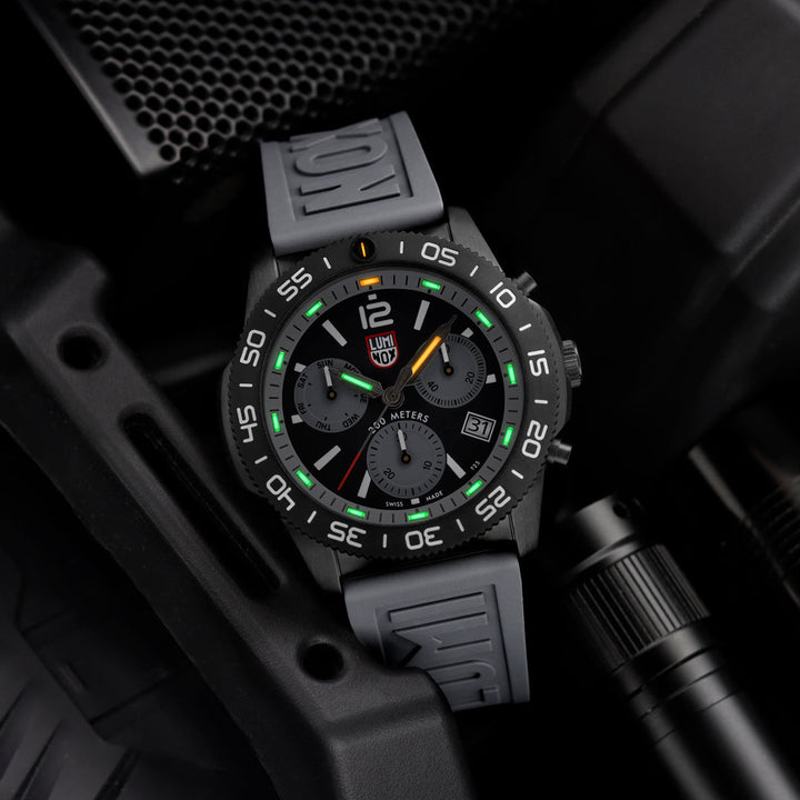 Black and gray watch with digital display on a dark background