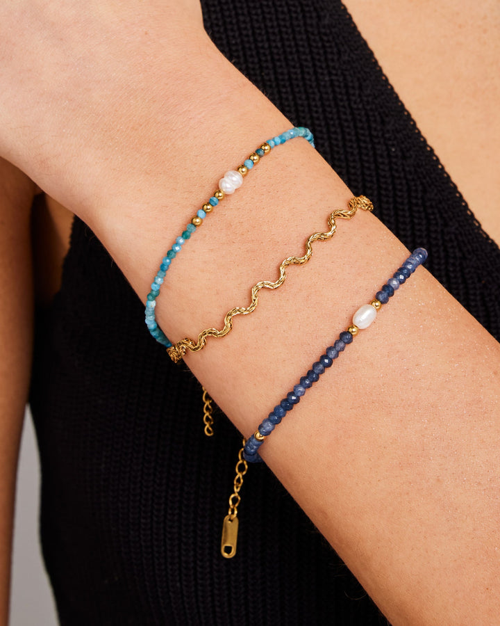 Solara Textured Wave Bracelet in Gold styled on a model, close-up detail — Zoe Olivia