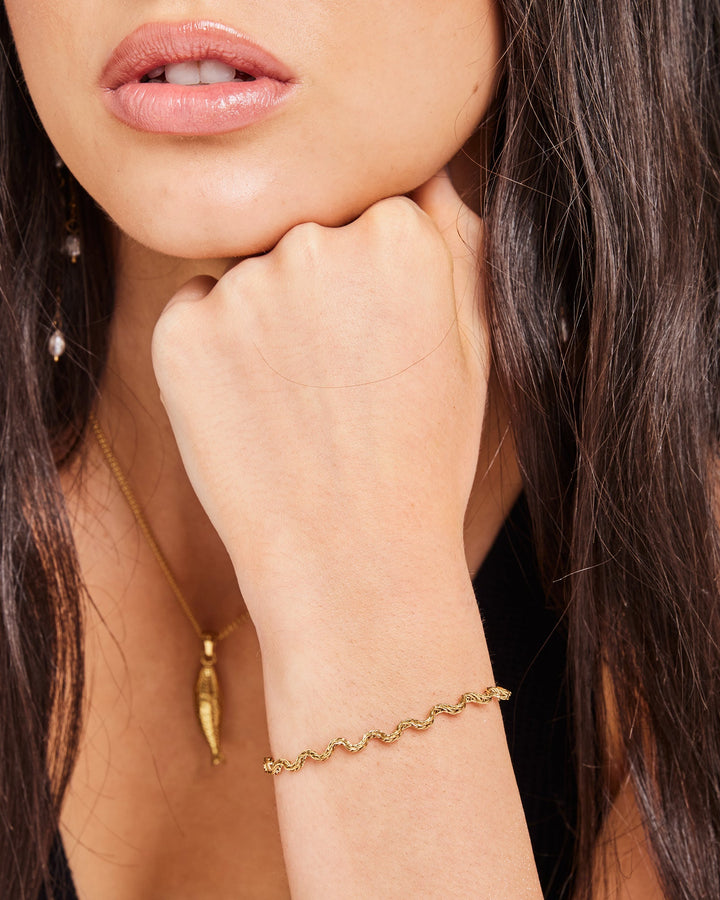 Solara Textured Wave Bracelet in Gold styled on a model, alternate view — Zoe Olivia
