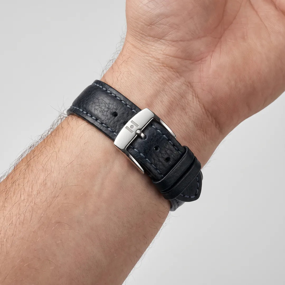 Man wearing the Lucca Black Tuscan Leather Watch Band, inner wrist view showing the stainless steel buckle with engraved H emblem