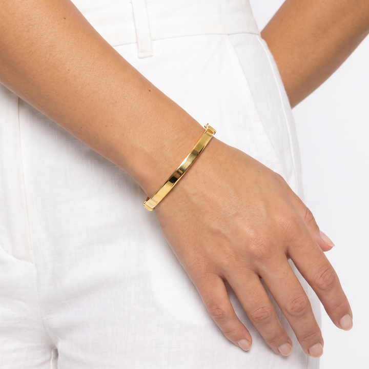 9K Yellow Gold Polished Hinged Bangle 60mm worn on wrist