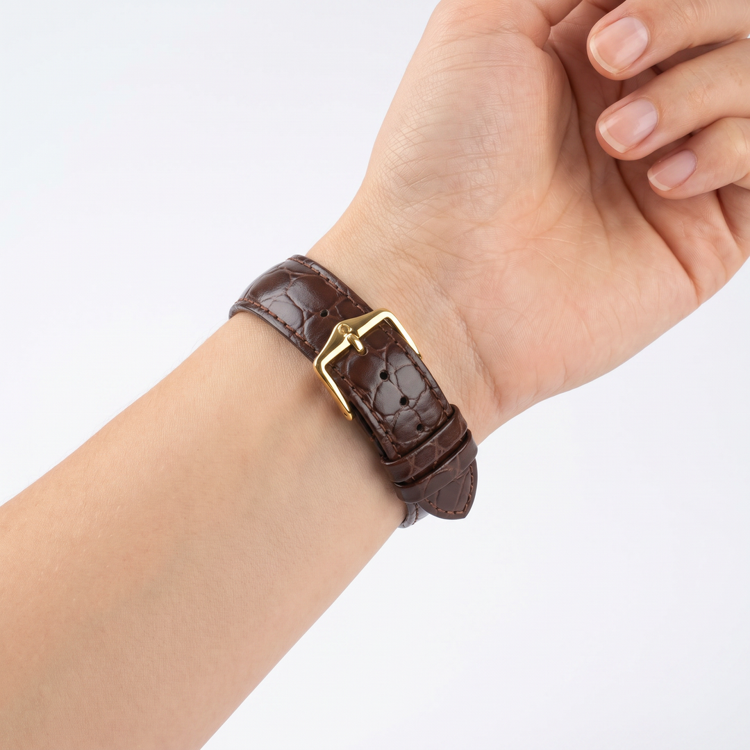 Model wearing the Hirsch Crocograin brown crocodile-embossed leather watch band with gold buckle