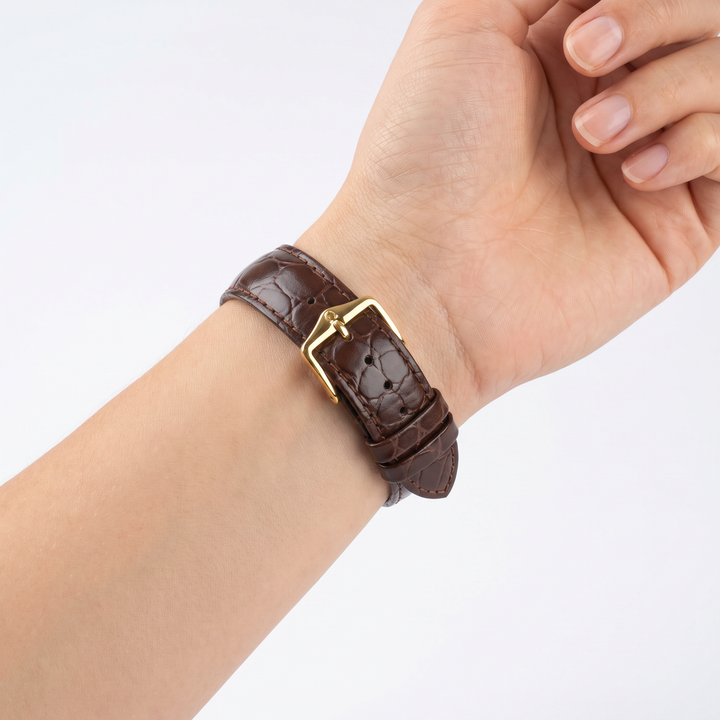 Model wearing the Hirsch Crocograin brown crocodile-embossed leather watch band with gold buckle