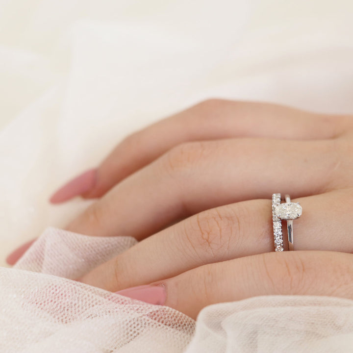 Oval diamond engagement ring and diamond wedding band in 9K white gold